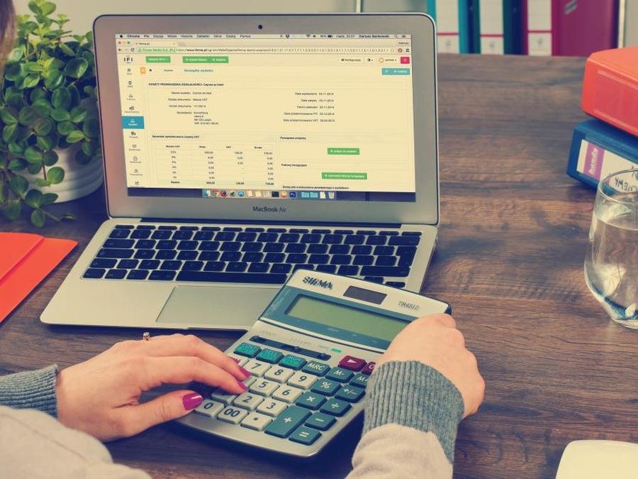Escritorio con calculadora, planilla y documentación contable